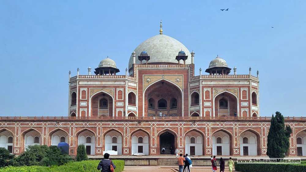 Humayun'S Tomb With A Dome And A Group Of People Walking Around