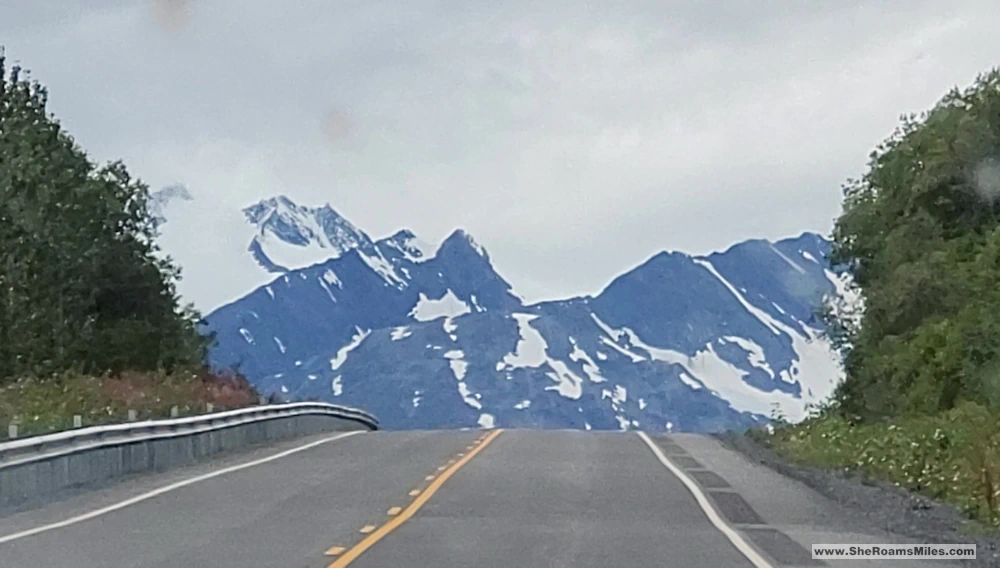 A Road Leading To A Snowy Mountain